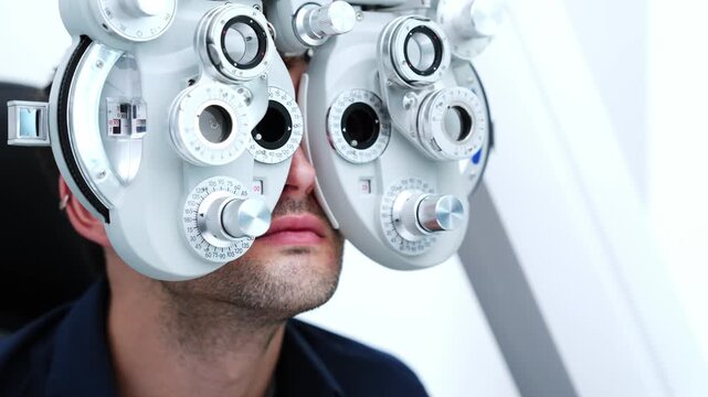 Detailed view of a vision test featuring a phoropter positioned on a patient's face inside an optometry office