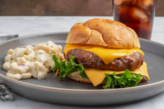 cheese burger   served  with macaroni sald