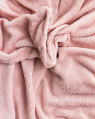 Soft pink fleece blanket texture, folded fabric background © MariiaDemchenko