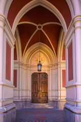 Obraz premium Gothic Portal and Carved Wooden Door of the Name of Mary Church
