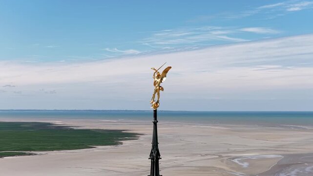 Archangel Michael golden statue spire Mont Saint-Michel abbey in Normandy, France landscape video