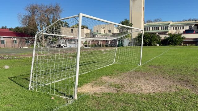 Football goal posts on a football field on a sunny day.