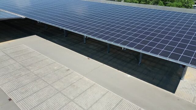 Factory hall with solar panels on roof, renewable energy for industrial production 4k