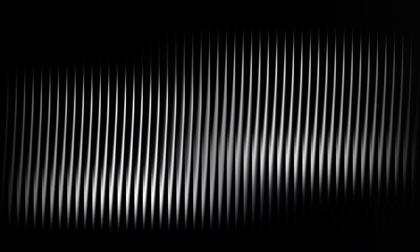 Lines of vertical silver metal creating abstract pattern on black background