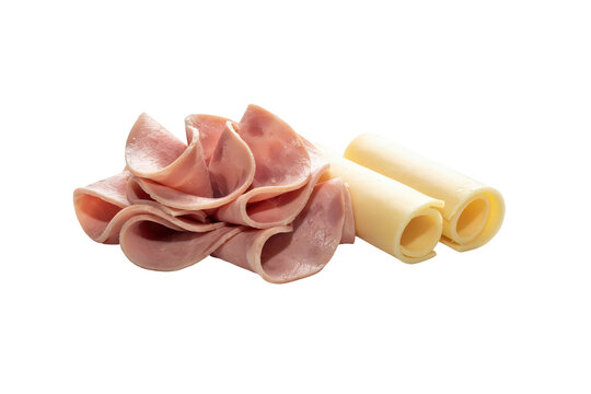 A single slice of deli ham folded into a rose shape next to two rolled slices of yellow cheddar cheese isolated on a black background