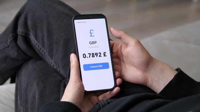 User viewing the GBP to USD rate at 0.7892. The modest yet consistent value reflects market stability. Ideal for conservative investments, safe-haven assets, and steady currency pairs stock footage.