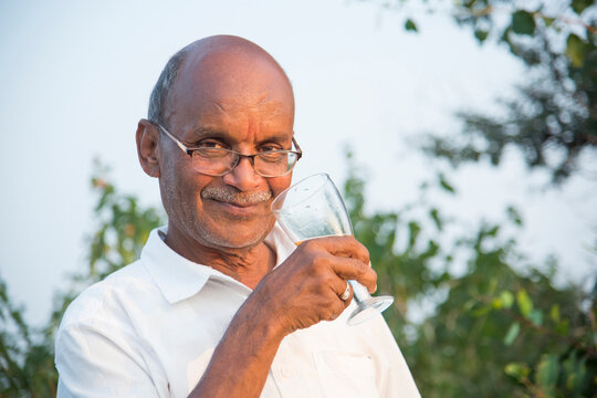 Cheerful man is celebrating with alcohol drink