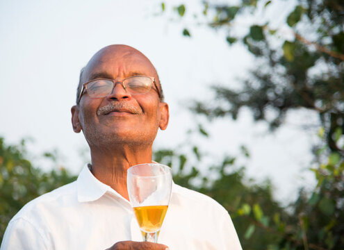 Cheerful man is celebrating with alcohol drink