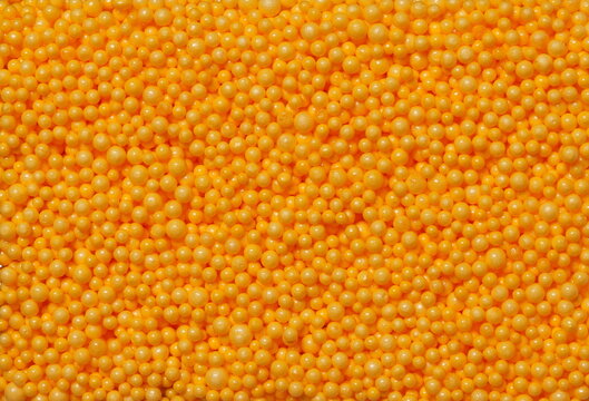 Orange circle styrofoam balls background and texture, color foam pattern