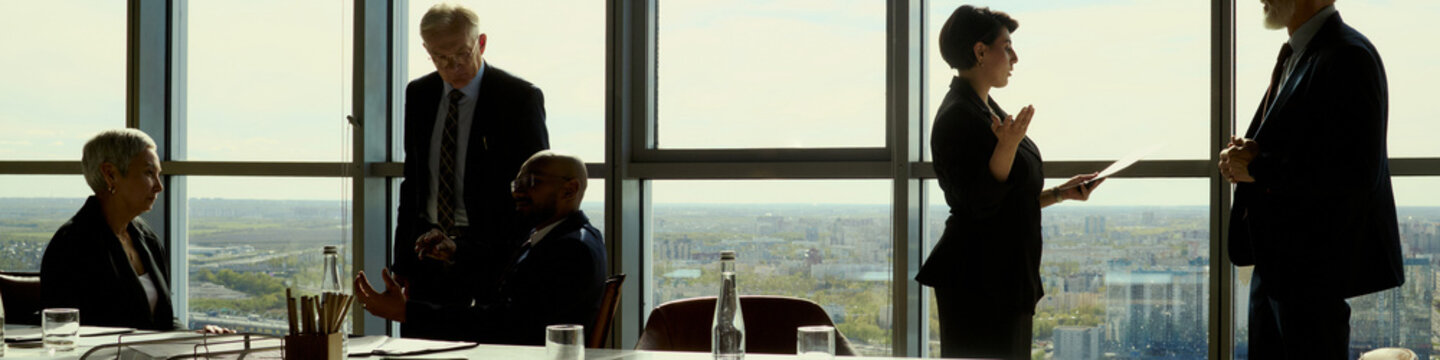 Header of diverse business team discussing oil industry strategy during corporate meeting, reviewing documents and planning operations. Ideal for energy leadership, investment, partnership marketing