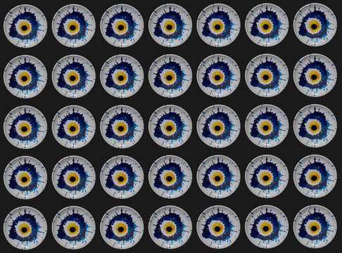 Creative pattern made of colorful blue and yellow evil eye on black background. 