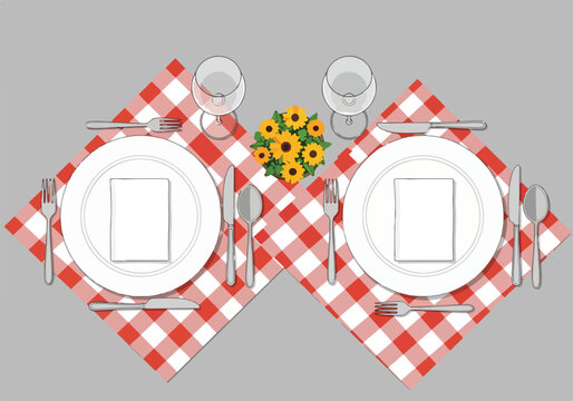 Overhead view of a table setting with plates, cutlery, glasses, and sunflowers