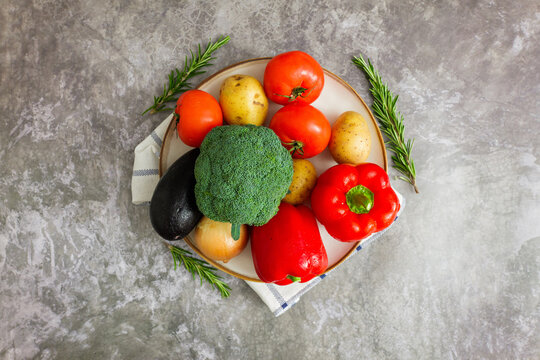 Colorful assortment of fresh vegetables on a rustic plate, ready to inspire a delightful meal or healthy snack preparation
