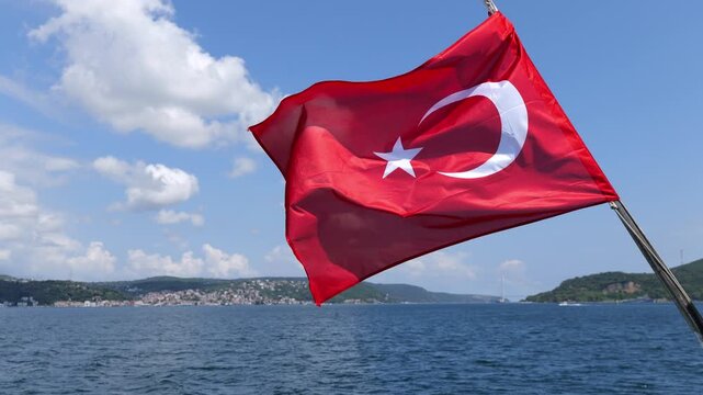 Turkish flag waving over the bosphorus strait in istanbul