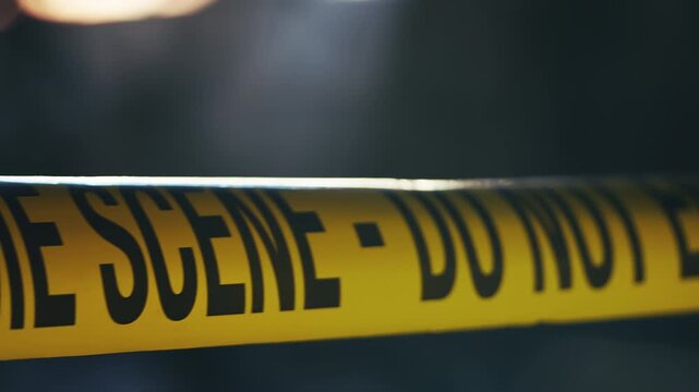 Police crime scene warning tape securing active murder investigation area