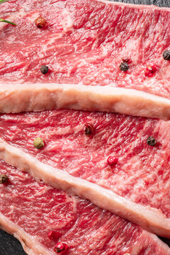 Sliced picanha beef with spices closeup. Traditional Portuguese food.