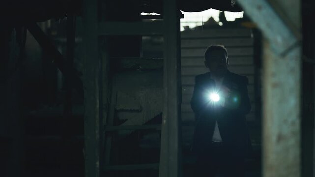 Male police detective with gun and flashlight searching for abducted victim