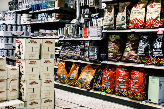 Display of Cases of Birra Moretti Italian Beer and Bags Of BBQ Charcoal Fuel With No People