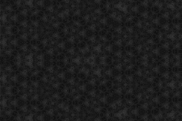 Fototapeta premium A dark charcoal grey background featuring a complex, repetitive geometric kaleidoscope pattern of interconnected circles and floral shapes. The matte surface suggests industrial metal or textured art 