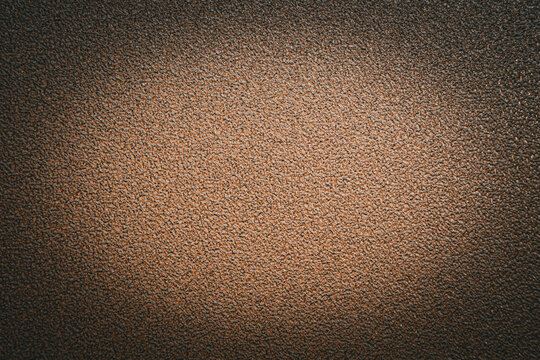 A warm brown background featuring a fine-grained texture and a prominent, smooth central gradient spotlight effect. The matte surface mimics earthy, organic, high-quality textured art paper.