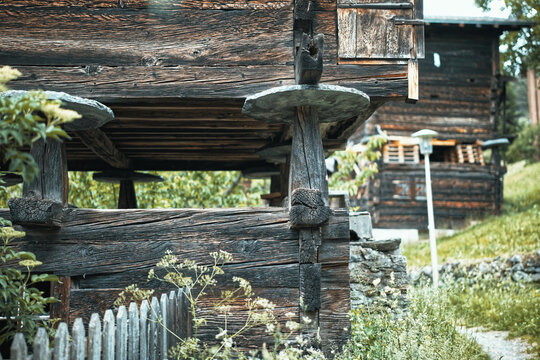Traditional wooden granary with stone mouse guards on pillars, Valais, Switzerland