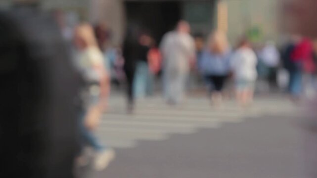 People walking cars moving on the road in the city unfocused blurred video urban life	
