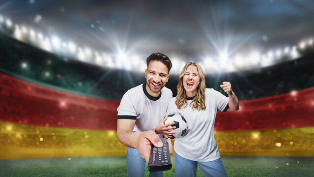 soccer fans family switching on a soccer game using the remote control on the TV. textured soccer game field with neon fog - center, midfield.