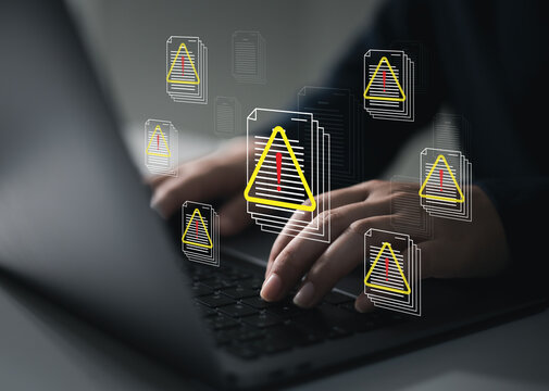 A data breach or leak occurs due to internal threats or unauthorized access. Hackers use laptop computers to steal documents.