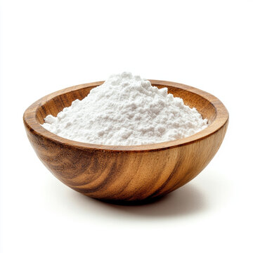 Bowl of white powder sits on table ready for baking or cooking tasks in a kitchen setting during daytime