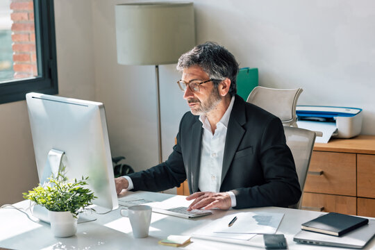 Concentrated elegant businessman working on a computer in the office