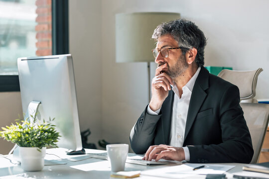 Concentrated elegant businessman working on a computer in the office