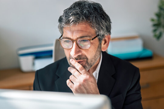 Concentrated elegant businessman working on a computer in the office