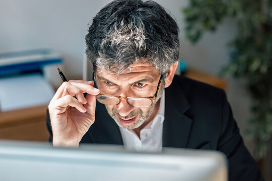 Concentrated elegant businessman working on a computer in the office