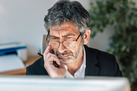 Concentrated elegant businessman working on a computer in the office