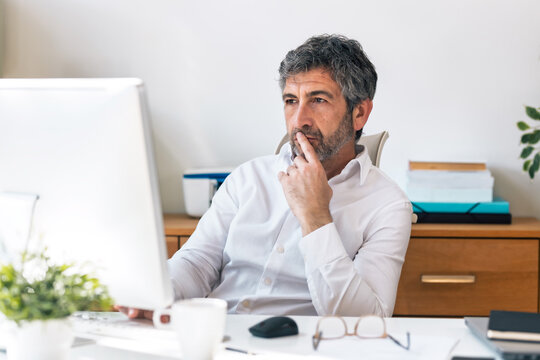 Concentrated elegant businessman working on a computer in the office