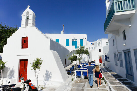 Couple walking down a charming street in Mykonos