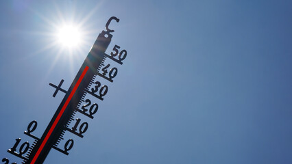 Hot weather, global climate change concept - Heat wave / Summer heat temperature celsius background banner long - Thermometer blue sky and sun rays