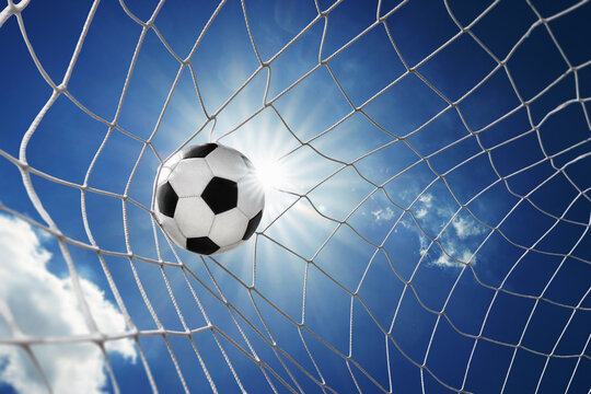  Soccer ball in soccer goal net, isolated on sunny blue sky background. soccer net.
