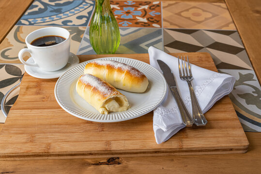 Brazilian enroladinho de queijo doce - Cream Rolls Served with Coffee Composition