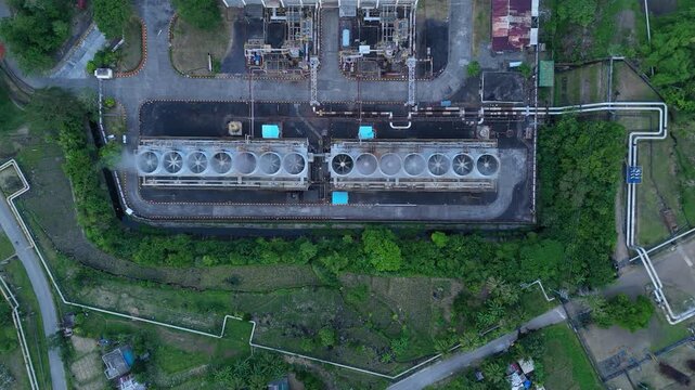 Vertical Aerial View of Tiwi Geothermal Power Plant Cooling System and Industrial Infrastructure in Albay, Philippines. Ideal for engineering and documentary concepts.