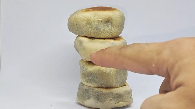 Finger counting stacked bakpia pastries