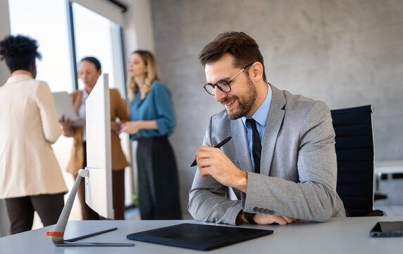 Young businessman using laptop computer in office. Manager thinks about successful financial ideas.
