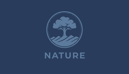 Naklejka premium Nature tree emblem logo design in a circular frame over rolling hills against a solid deep navy blue background.