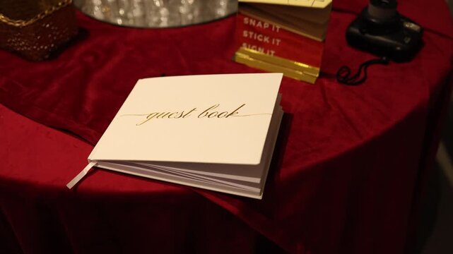 Guest book on red table at event
