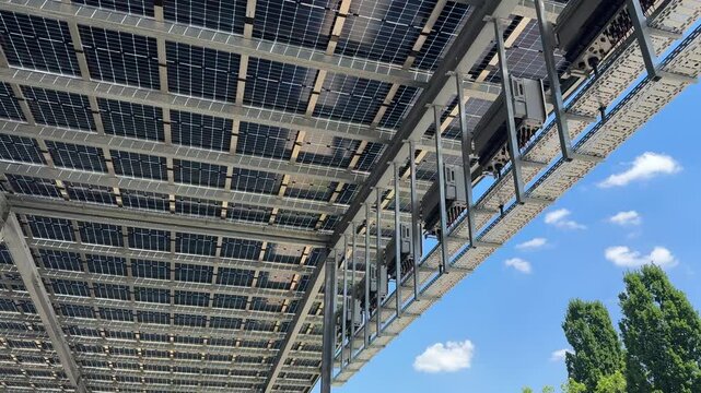 Factory hall with solar panels on roof, renewable energy for industrial production  with blue Sky 4k