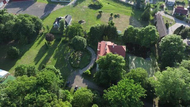 Aerial southern Poland Palace manor house circle climb 3. Southern Poland. Historic luxury palace, manor house, castle starting in 1525. Farming agriculture economy. Knights residence, hunting lodge.
