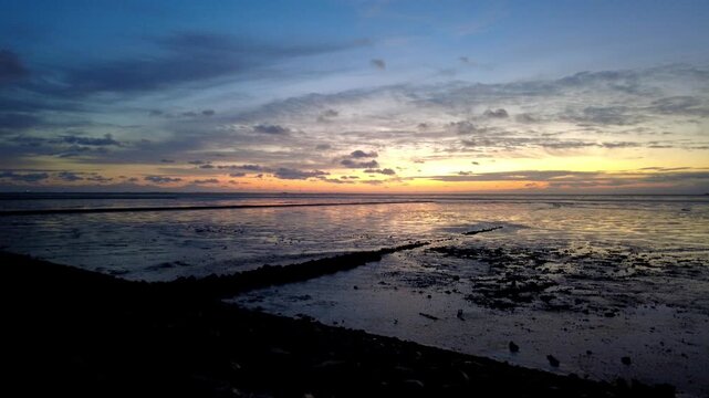 Timelapse at Sunset at Norderhafen (northern harbor) of the Nordstrand peninsula at the Wadden Sea National Park in Schleswig-Holstein, Germany, Europe