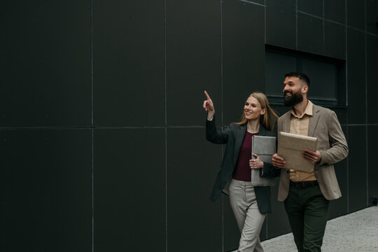 Business colleagues walking and pointing to future vision