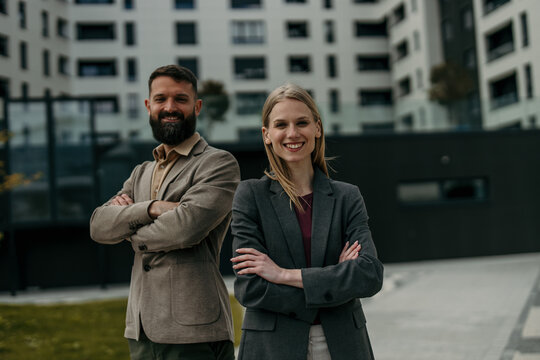 Business partners standing outdoors creating strong professional team