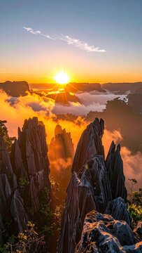 Golden sunrise illuminates dramatic limestone karsts emerging from a sea of clouds.